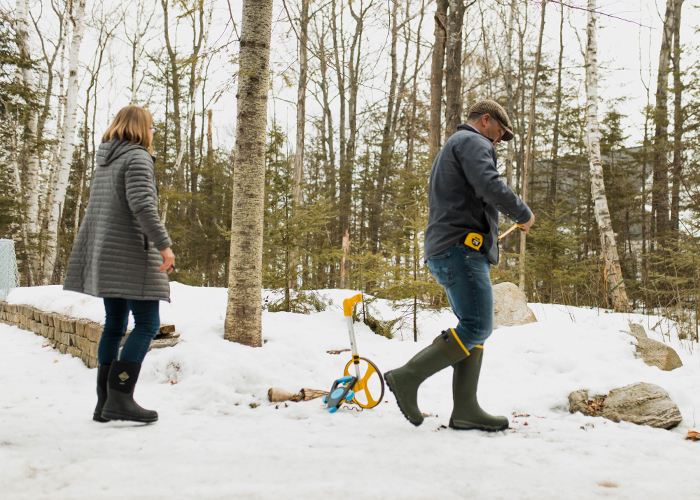 2 Vidosh North employees measuring for landscaping